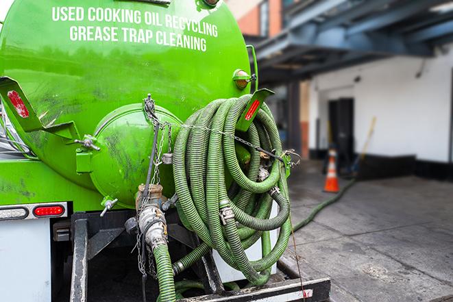 grease trap pumping truck in action in Cameron Park